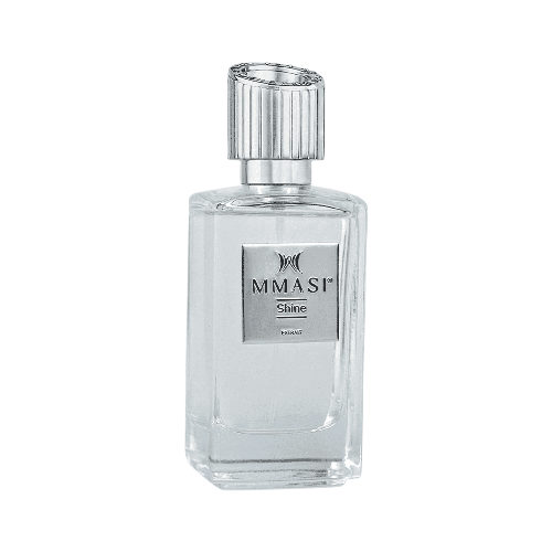 A clear glass perfume bottle with a silver cap and a label that reads "MMASI Shine Extrait”